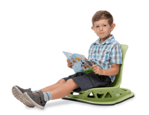 boy reading while sitting on lime green floor rocker